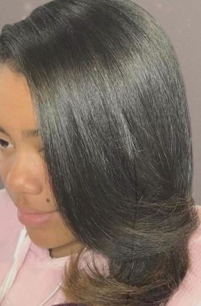 Glossy silk press with a soft curled end